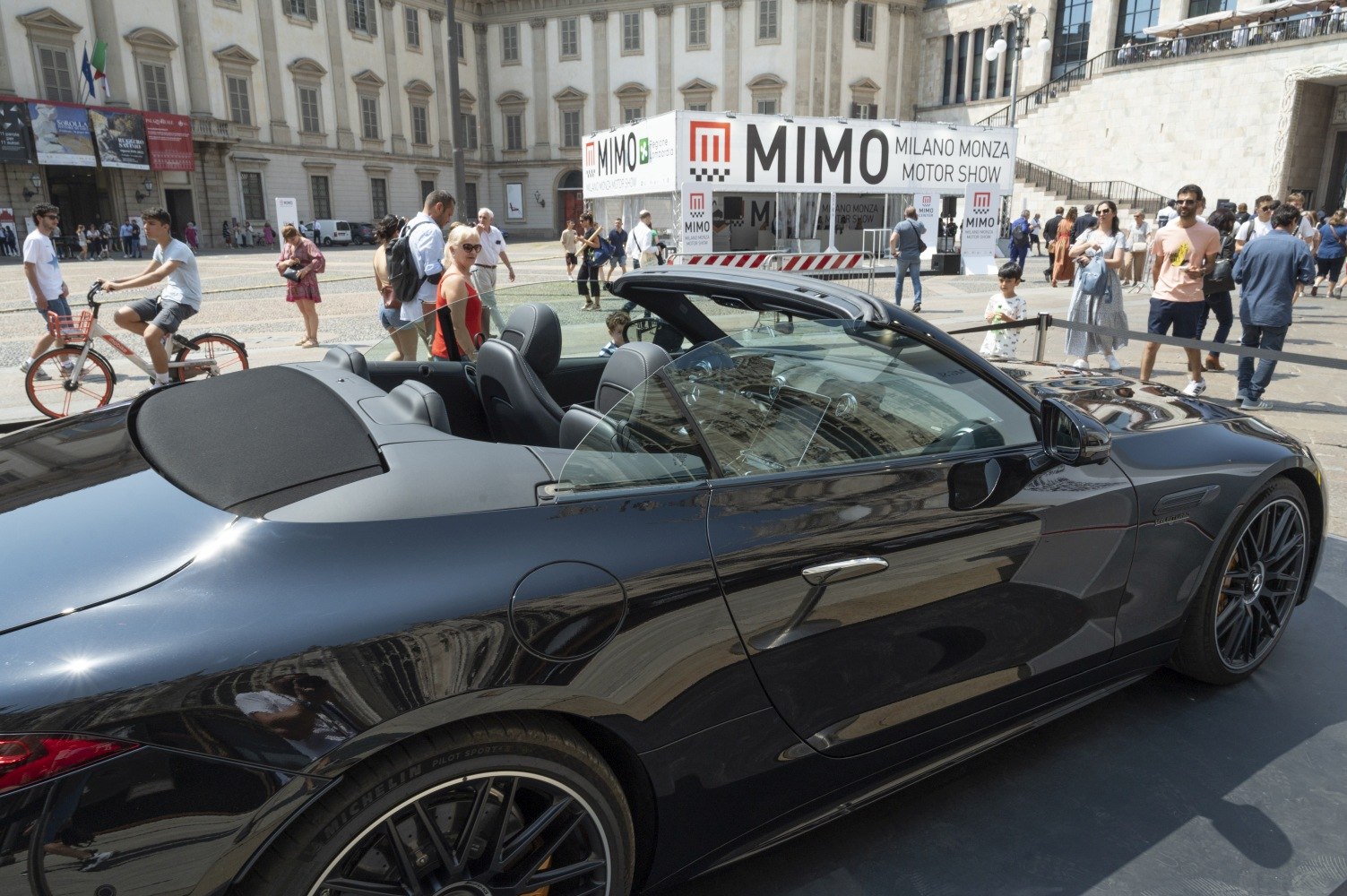 Black convertible roadster with open roof and sleek side profile