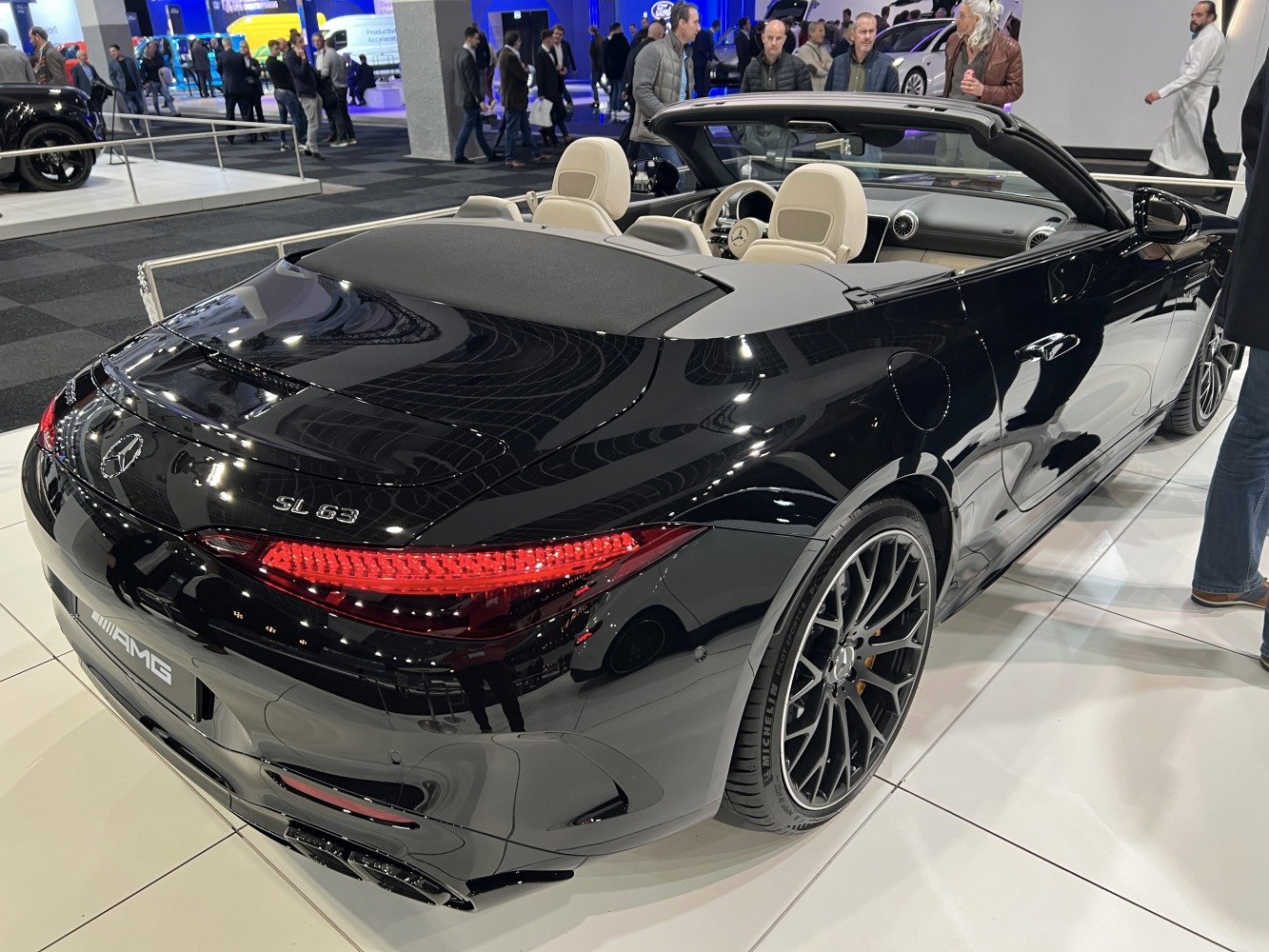 Convertible rear view with open-top luxury interior, AMG wheels, and LED taillights.