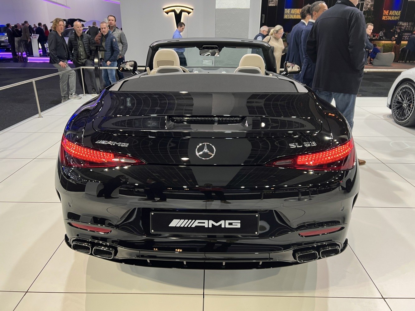 Rear view of a black convertible with AMG badges and quad exhaust