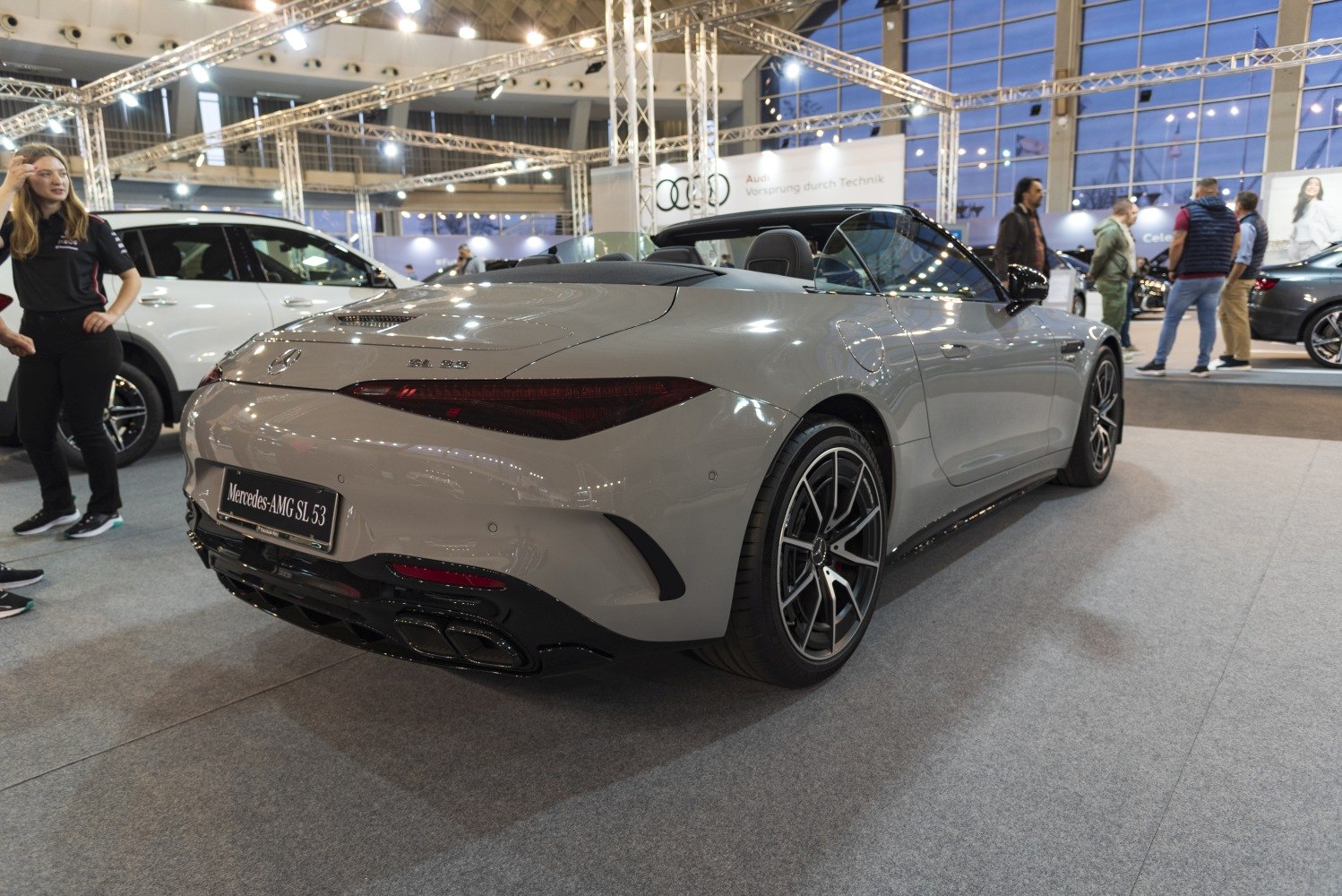 Rear view of a sporty convertible with sleek tail lights and quad exhausts