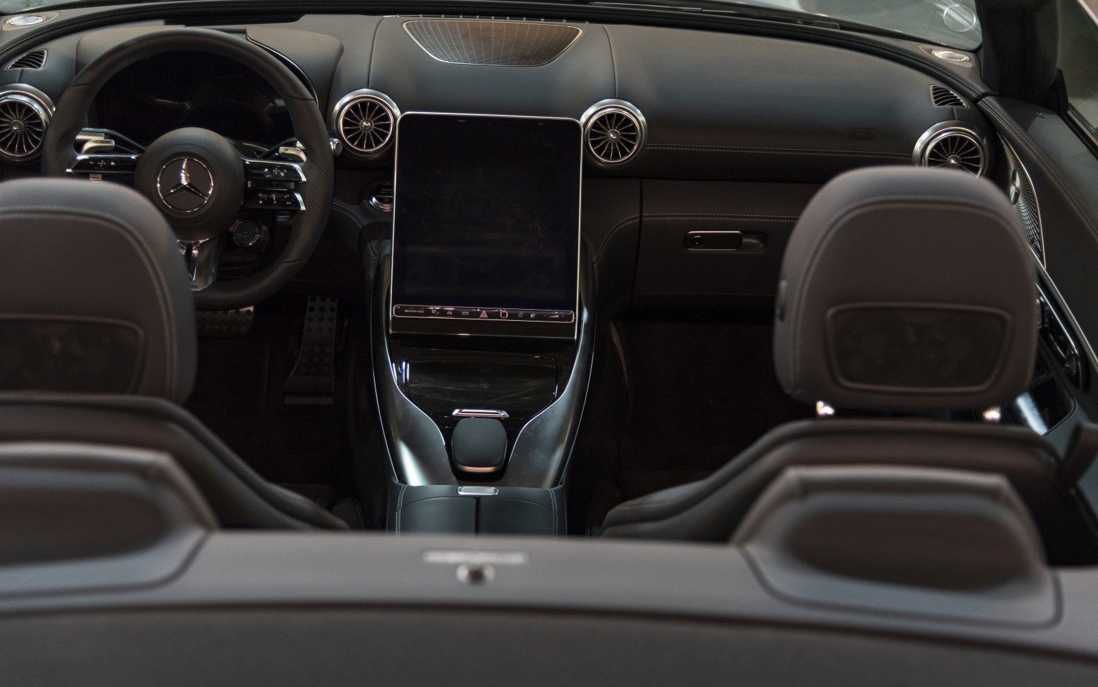Large vertical touchscreen and round turbine air vents in a luxury convertible interior