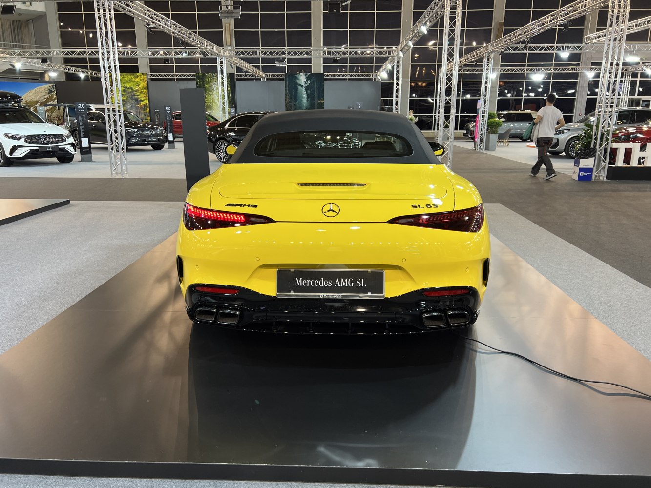 Rear view of yellow convertible with quad exhausts and LED taillights