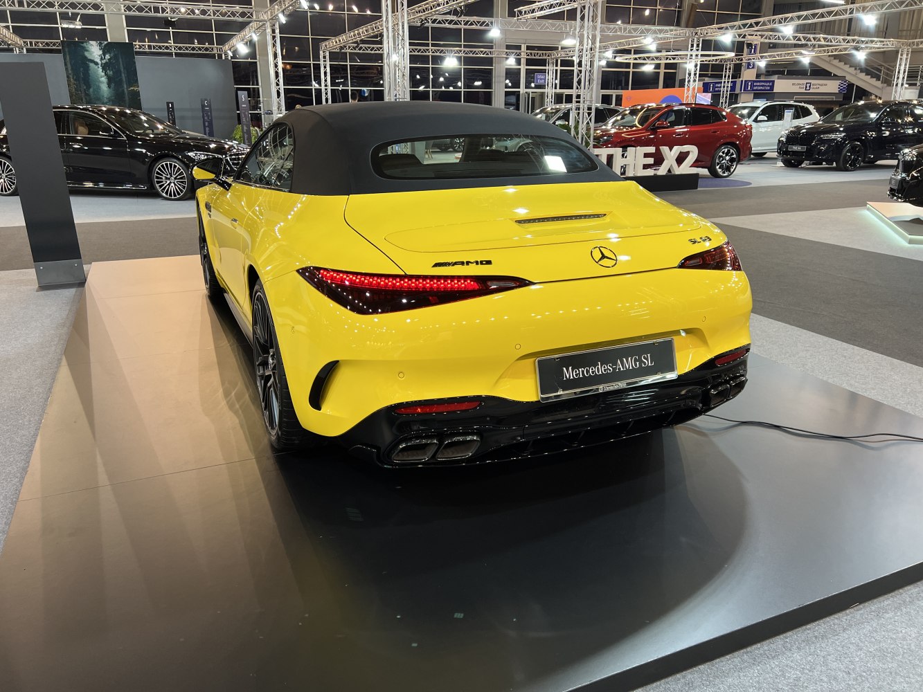 Bright yellow convertible rear with sleek taillights and quad exhausts