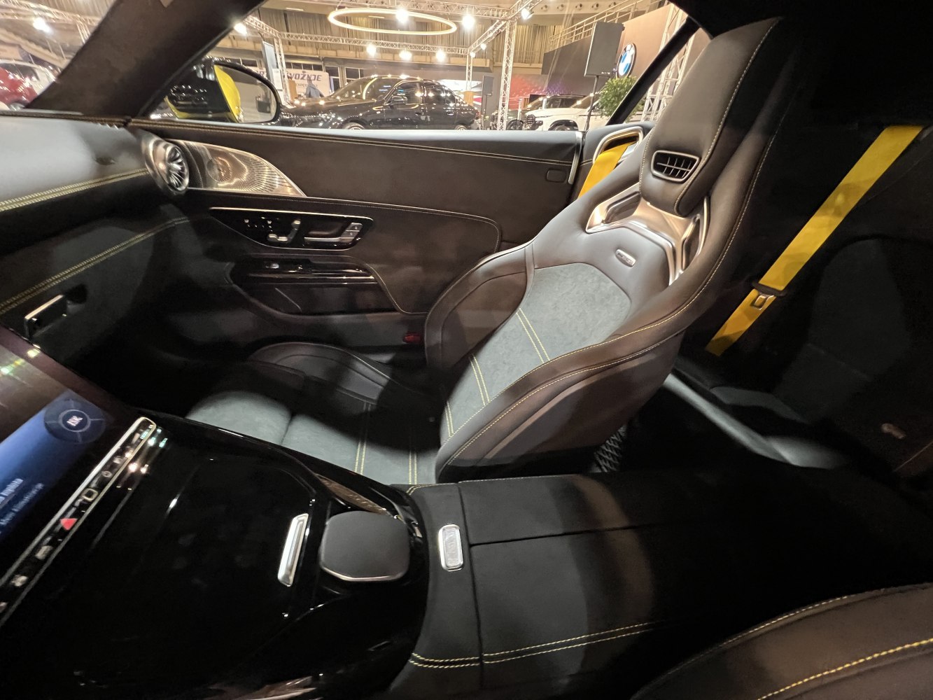 Modern sports seat with yellow stitching and advanced door controls