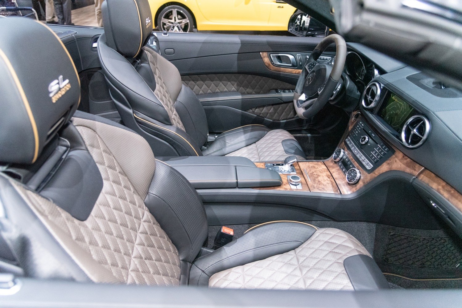 Quilted leather seats and wood trim dashboard interior features.