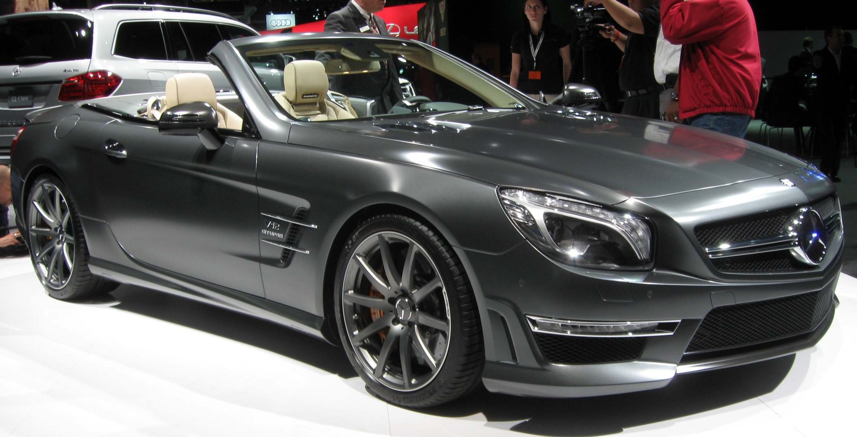 Sleek matte gray convertible showcasing V12 biturbo badge and sporty alloy wheels.
