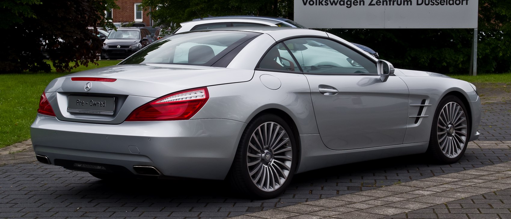 Sleek silver luxury convertible rear with LED taillights and multi-spoke wheels