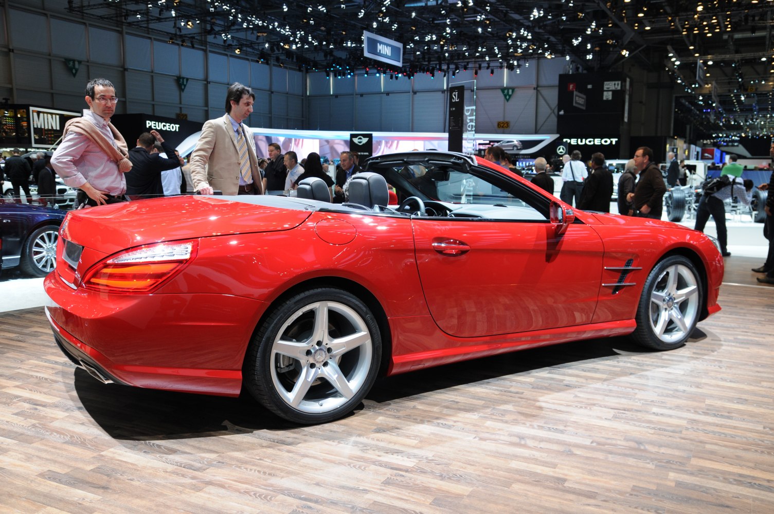 Red convertible sports coupe with five-spoke alloy wheels and two-door design