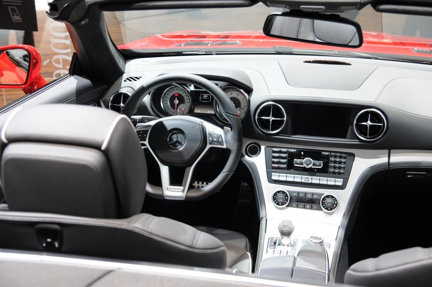 Steering wheel, dashboard, center console interior with air vents and controls