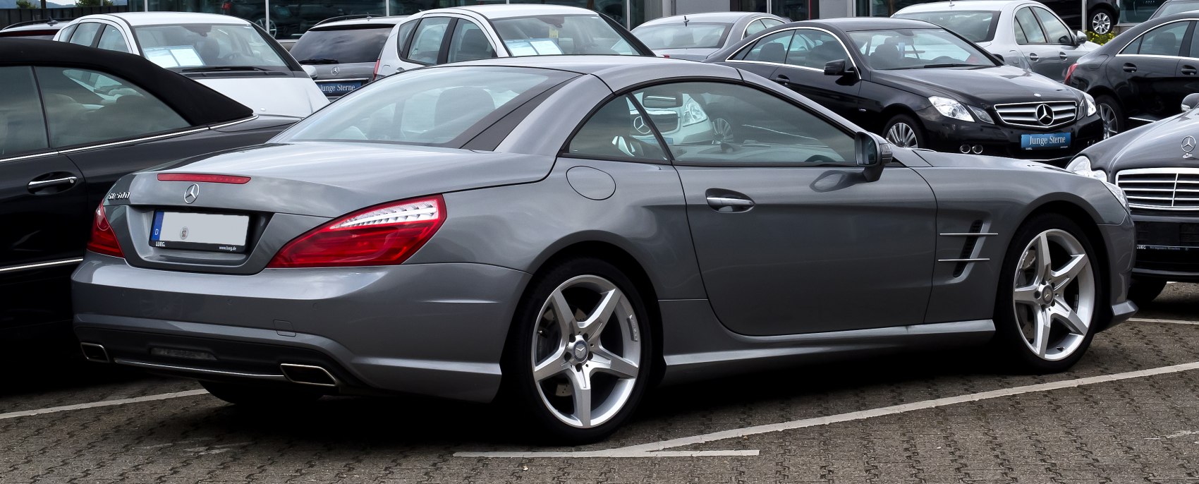 Rear-side view of a convertible roadster with alloy wheels.