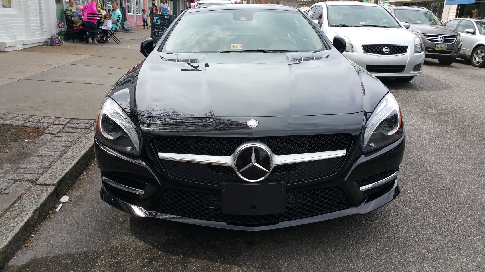 Front grille and headlights view of a luxury coupe in black.