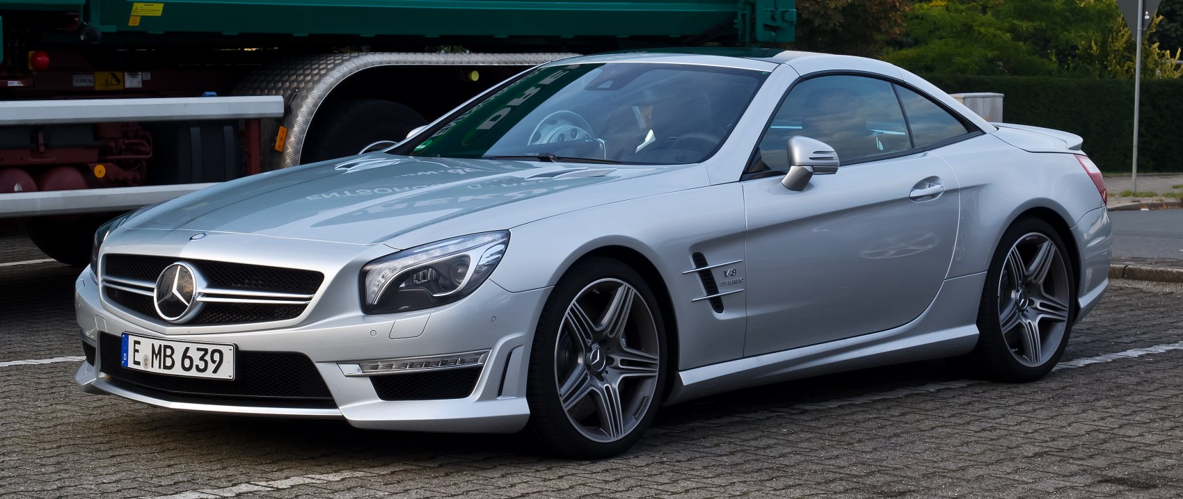 Silver luxury coupe with AMG V8 badge and sporty wheels