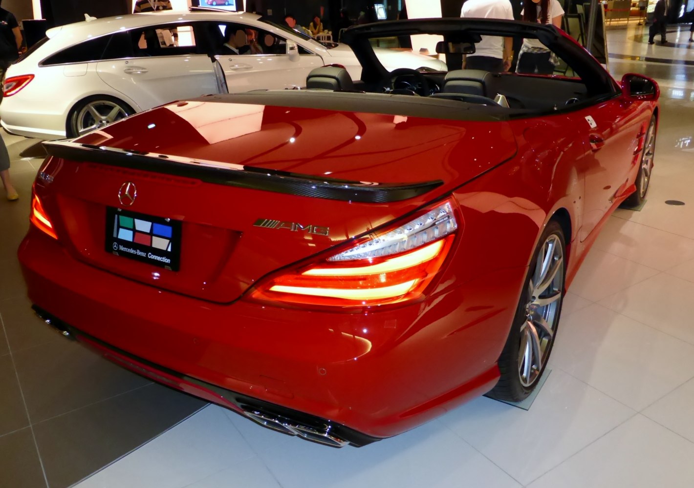 Rear view of red convertible with AMG badge and distinctive taillights