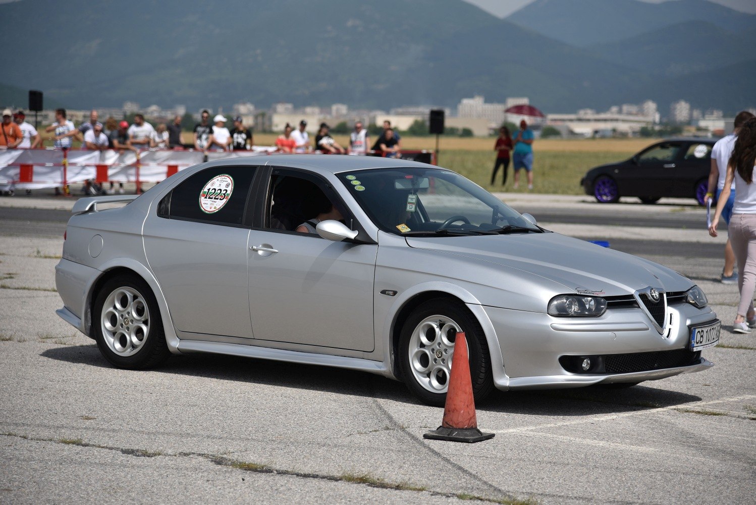 Silver sedan with distinctive front headlights and rear design.