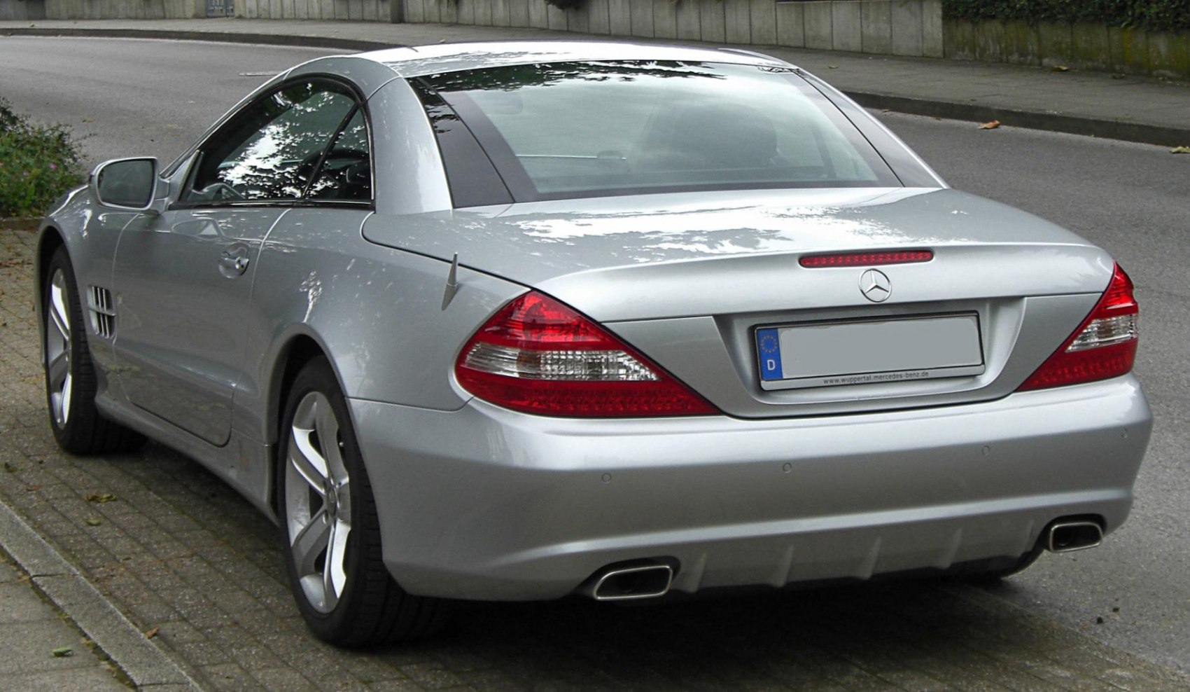 Rear view of luxury coupe with sleek taillights and dual exhaust