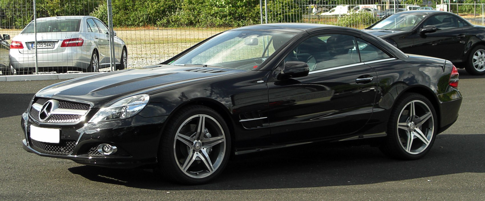Black luxury coupe with AMG wheels and sporty front grille.