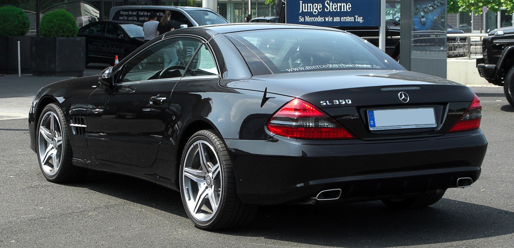 Rear three-quarter view with tail lights and alloy wheels