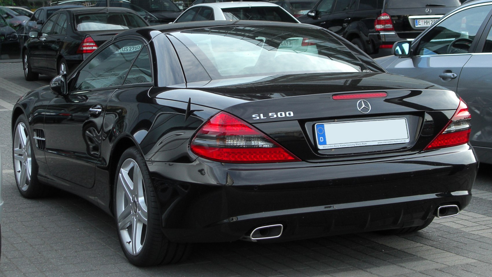 Rear view of luxury coupe with distinctive tail lights and dual exhaust tips