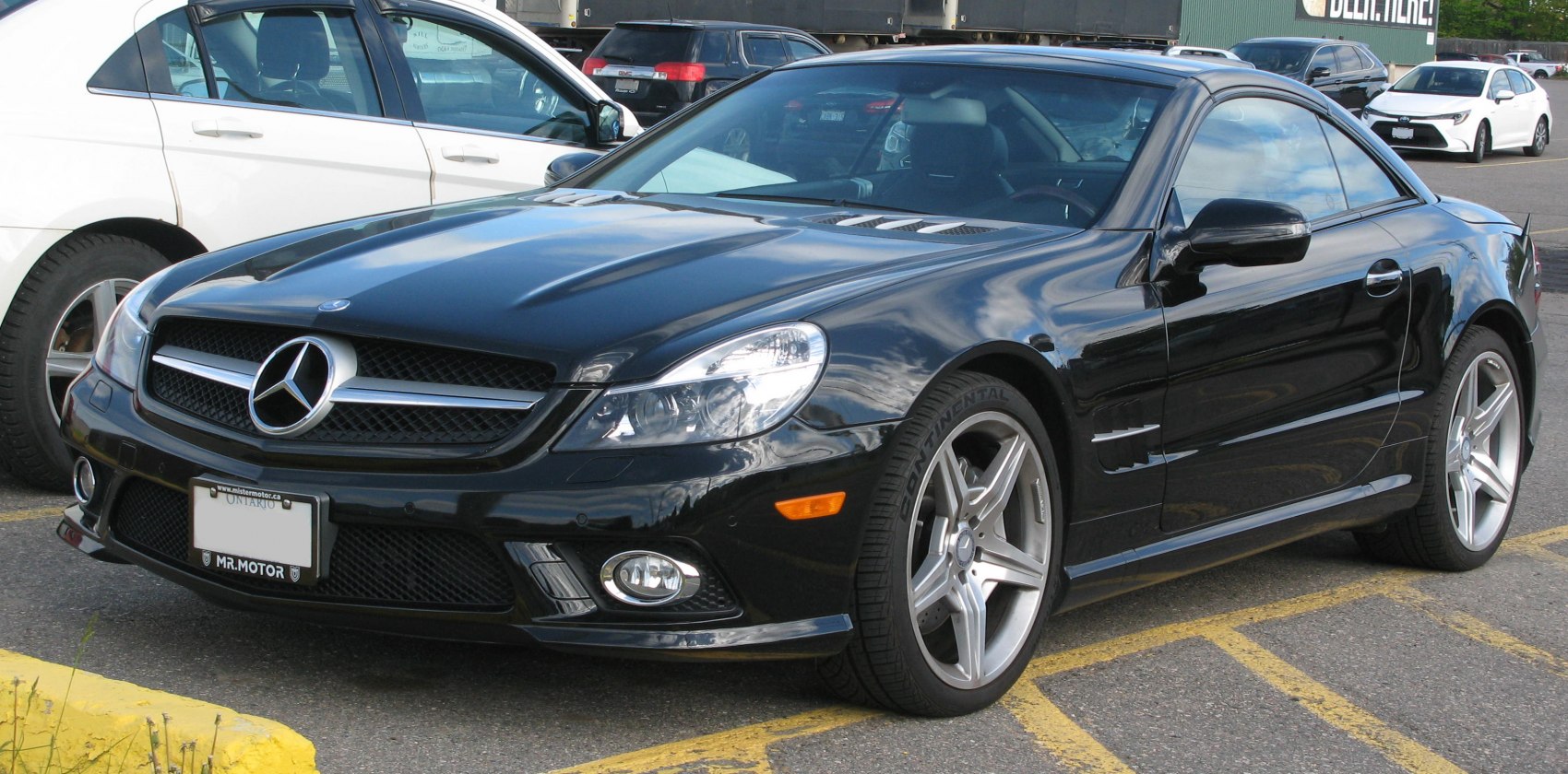 Sleek black luxury roadster front with distinctive grille and alloy wheels