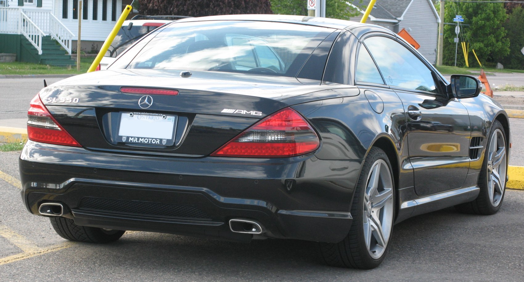 Rear view of black Mercedes SL with AMG badge and dual exhausts