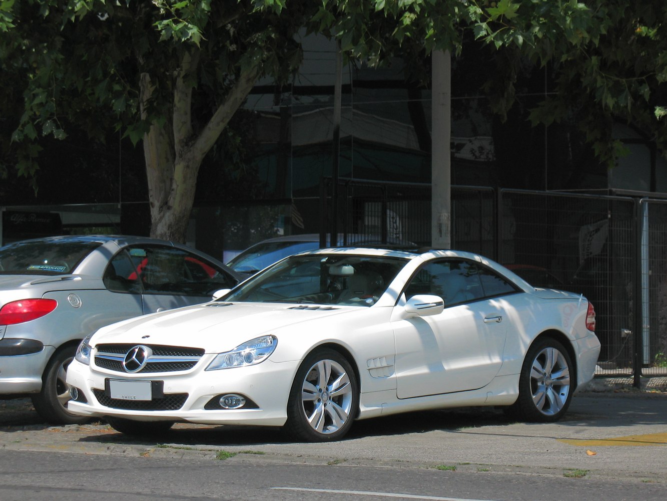 White coupe with distinct front grille and alloy wheels