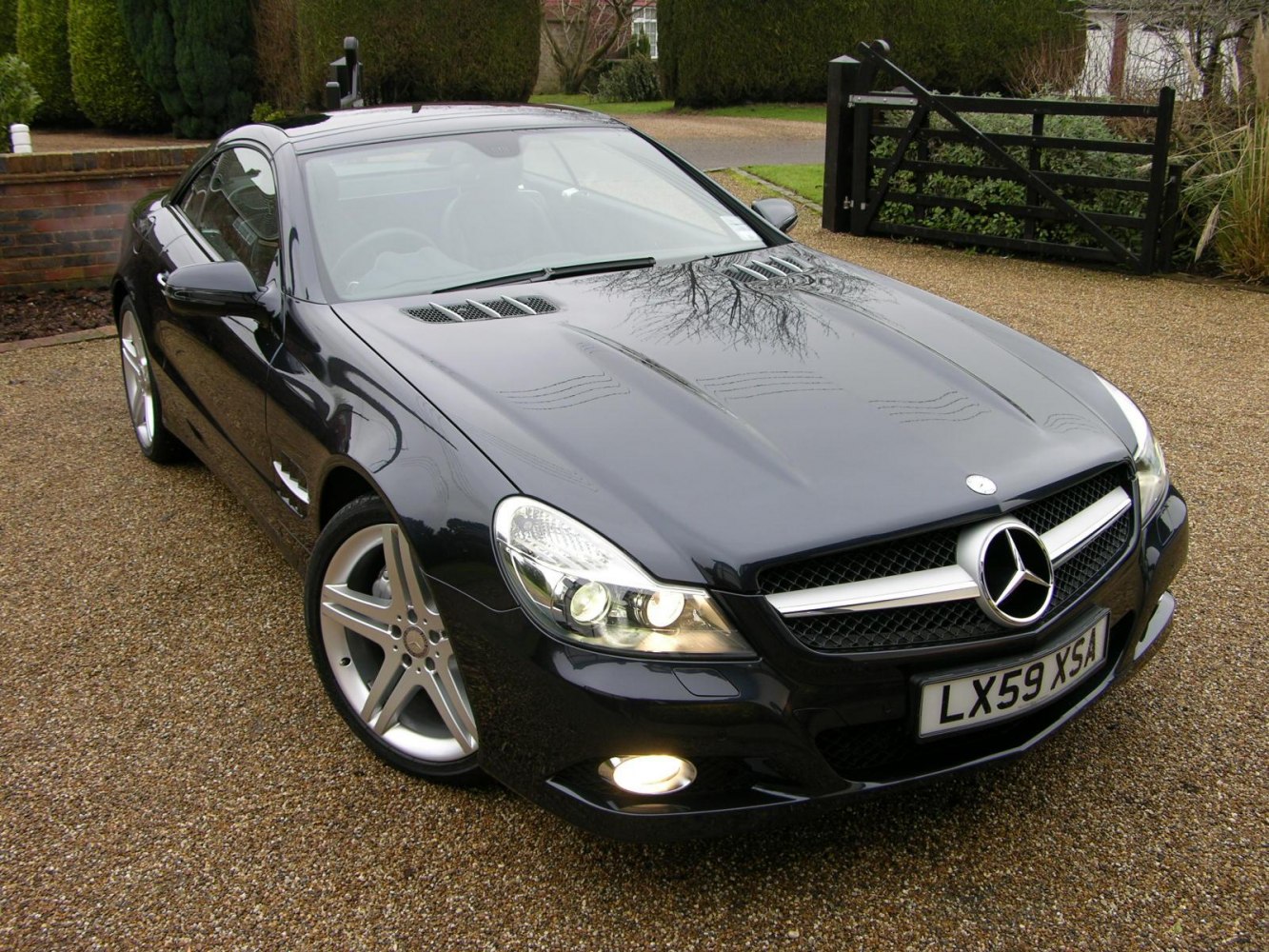 Front grille, headlights, fog lights, and alloy wheels of a sleek coupe