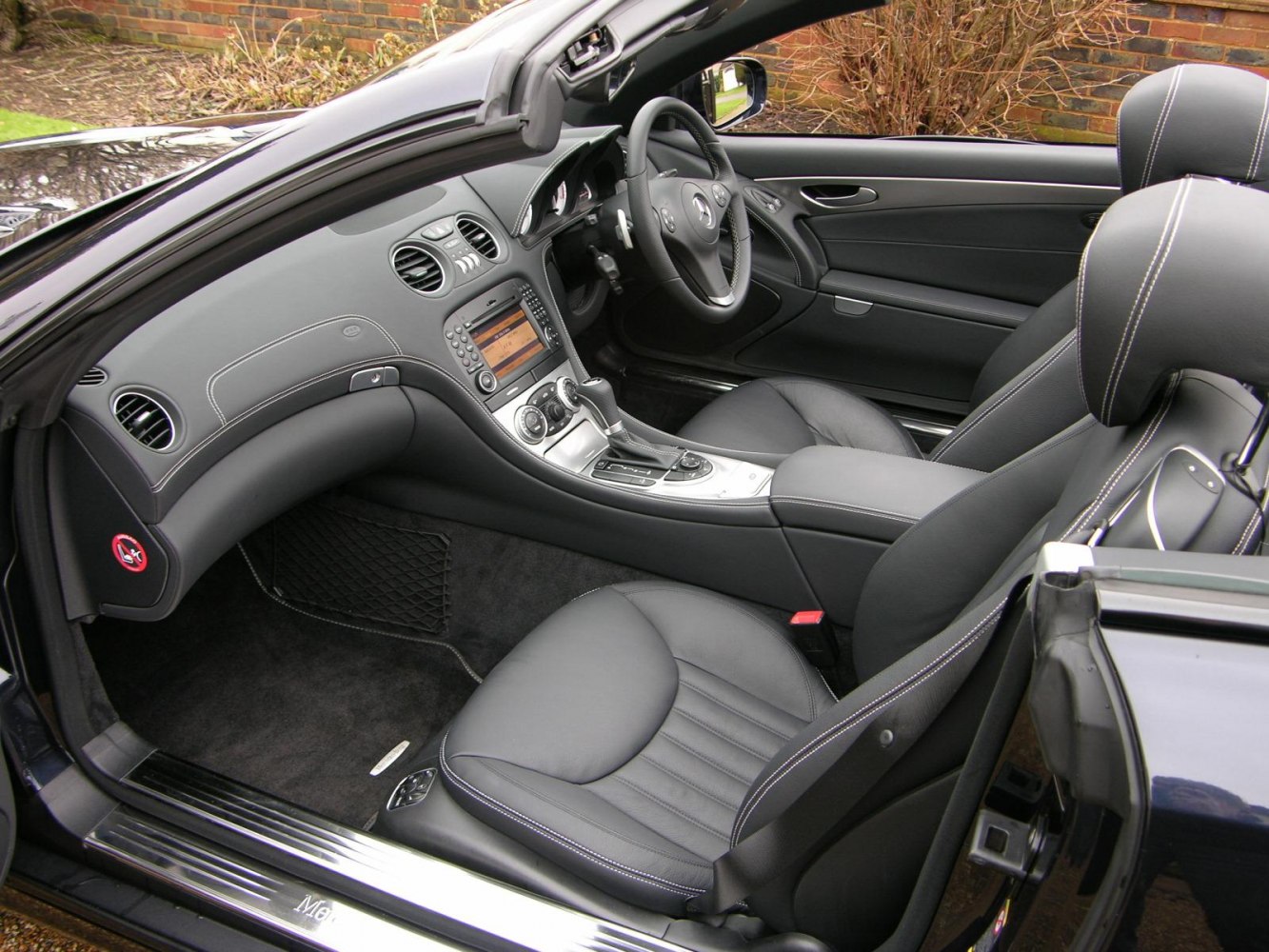 Luxury convertible interior with leather seats and advanced dashboard controls
