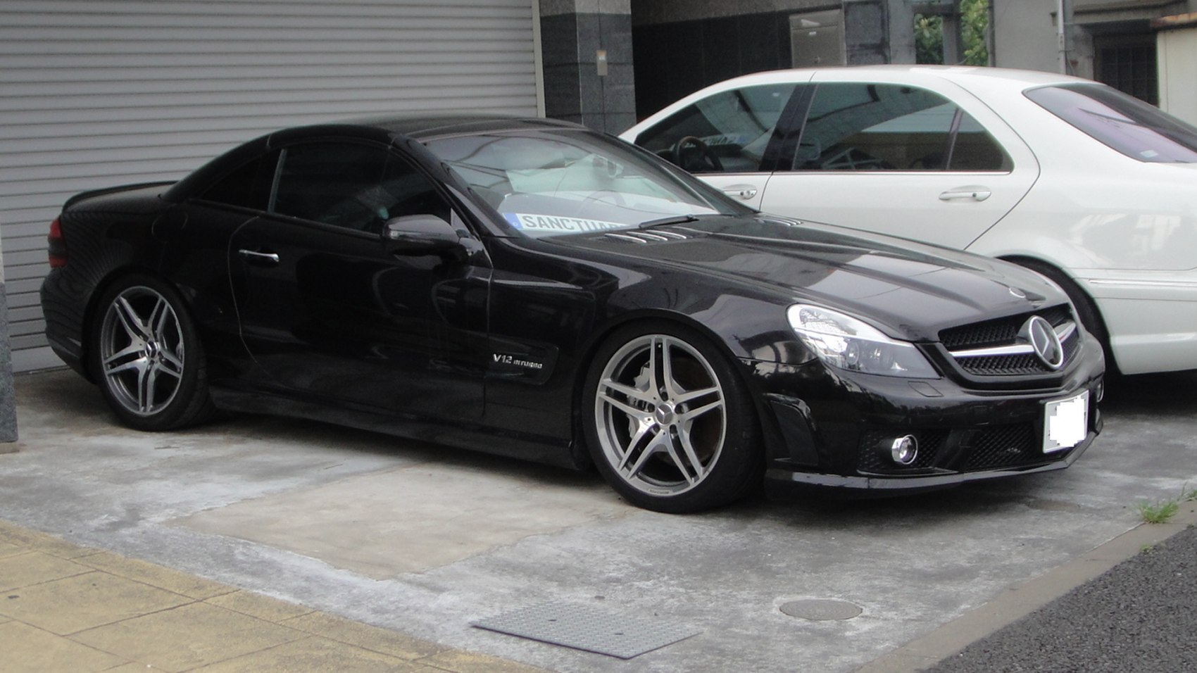 Black coupe with V12 biturbo badge and five-spoke alloy wheels