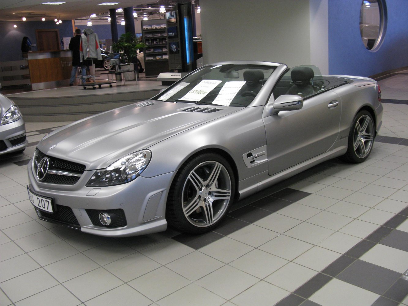 Convertible with silver body, alloy wheels, and sporty front design