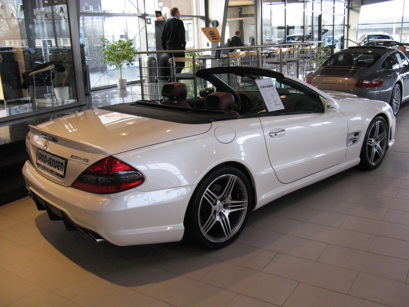 Convertible rear-side view with AMG wheels in showroom