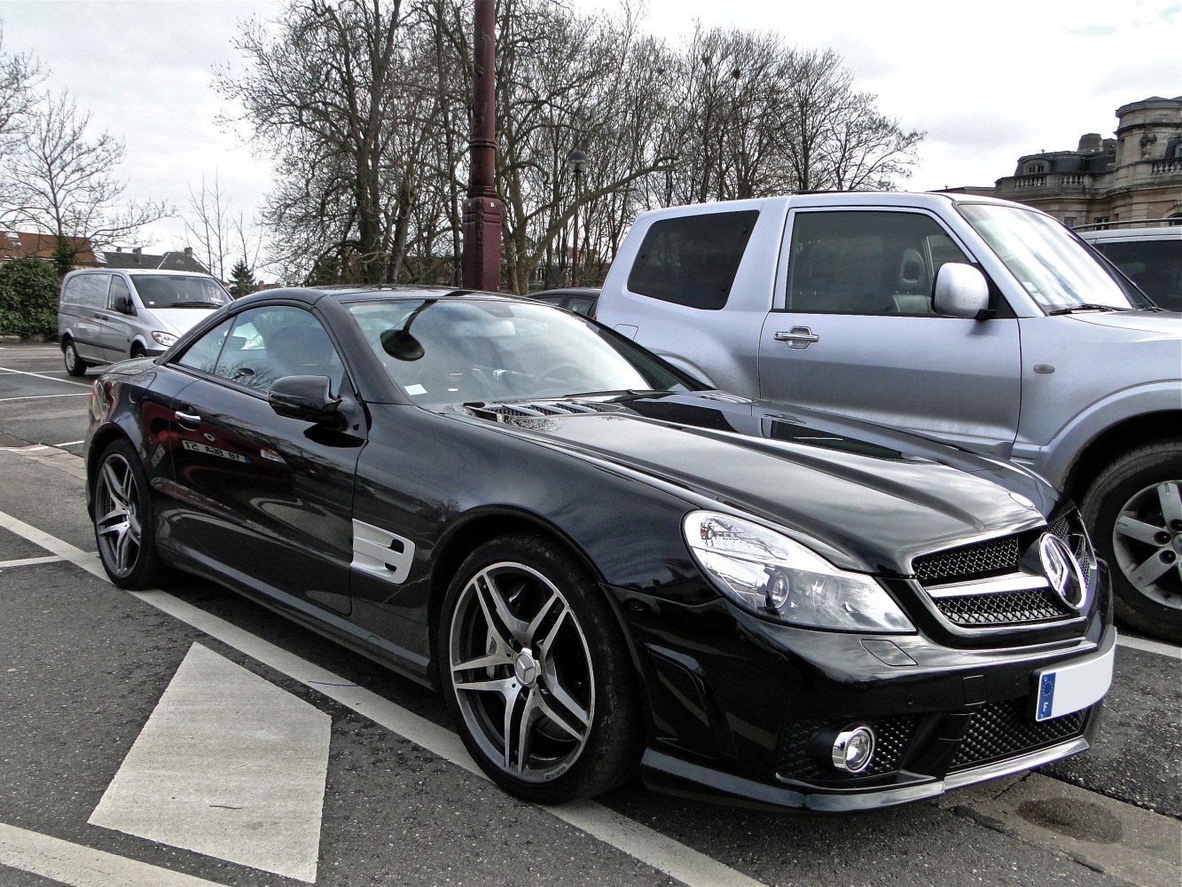 Black two-door coupe with sporty alloy wheels and distinctive front grille