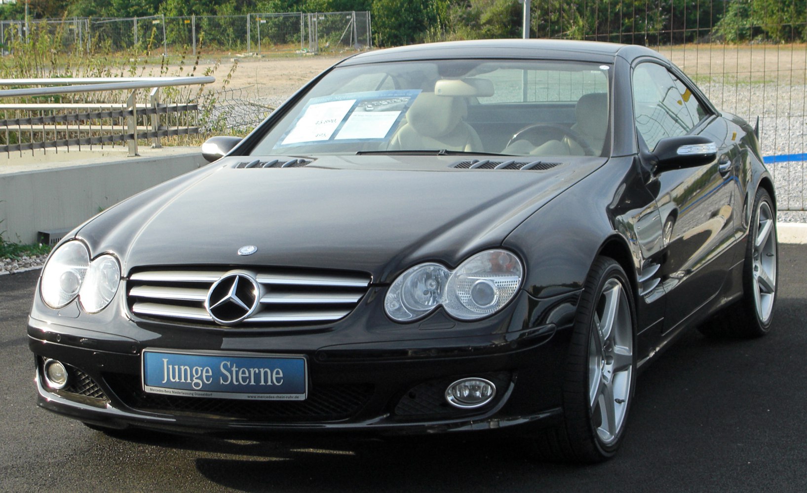 Quad round headlights and sporty front grille on a luxury coupe.