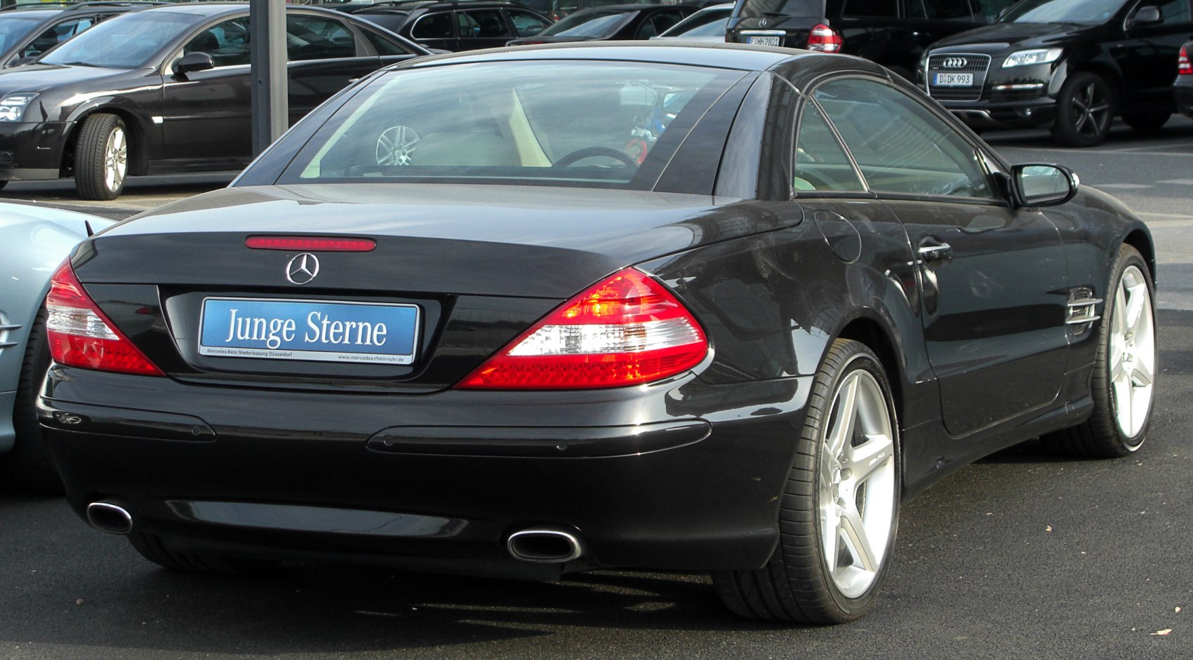 Rear view of sporty coupe with dual exhaust and distinctive tail lights