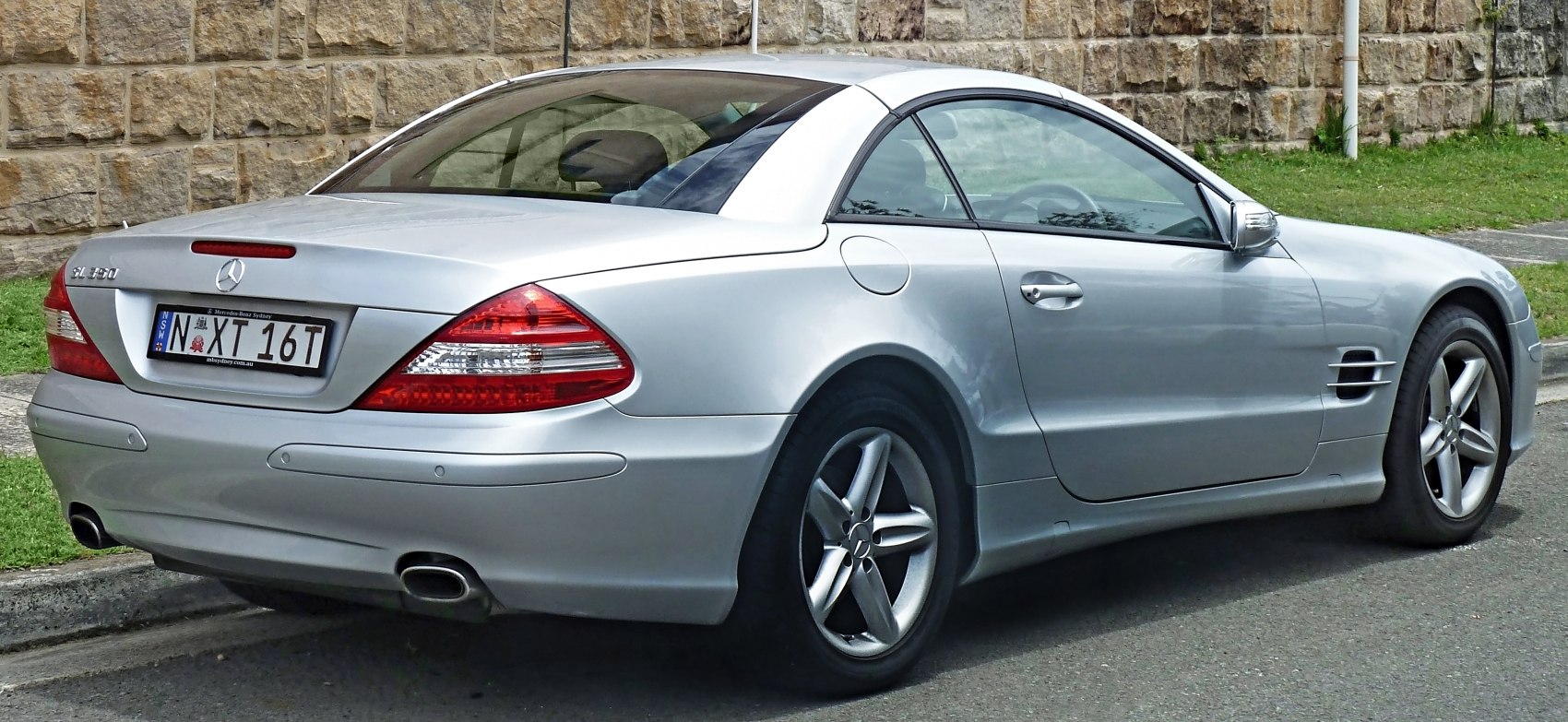 Silver silver coupe with distinct tail lights and dual exhaust