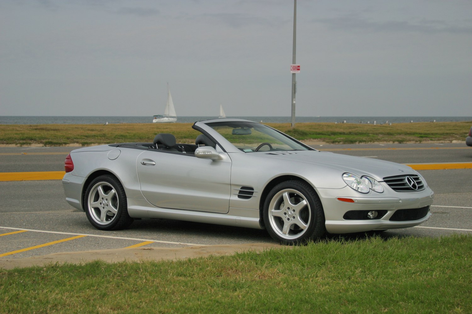 Silver convertible roadster with five-spoke alloy wheels and side vents