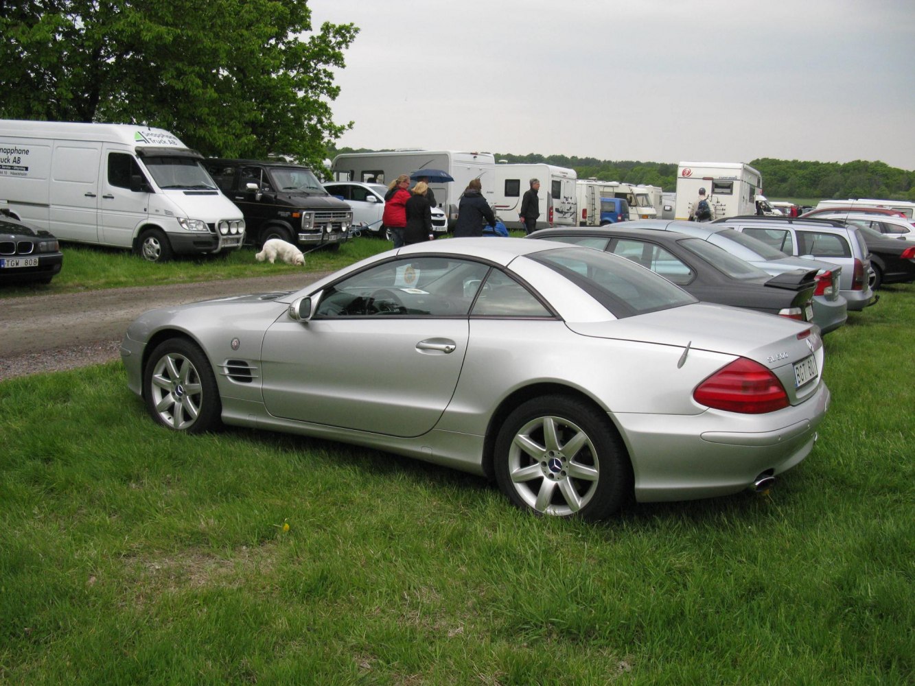 Silver two-door convertible with hardtop roof and alloy wheels