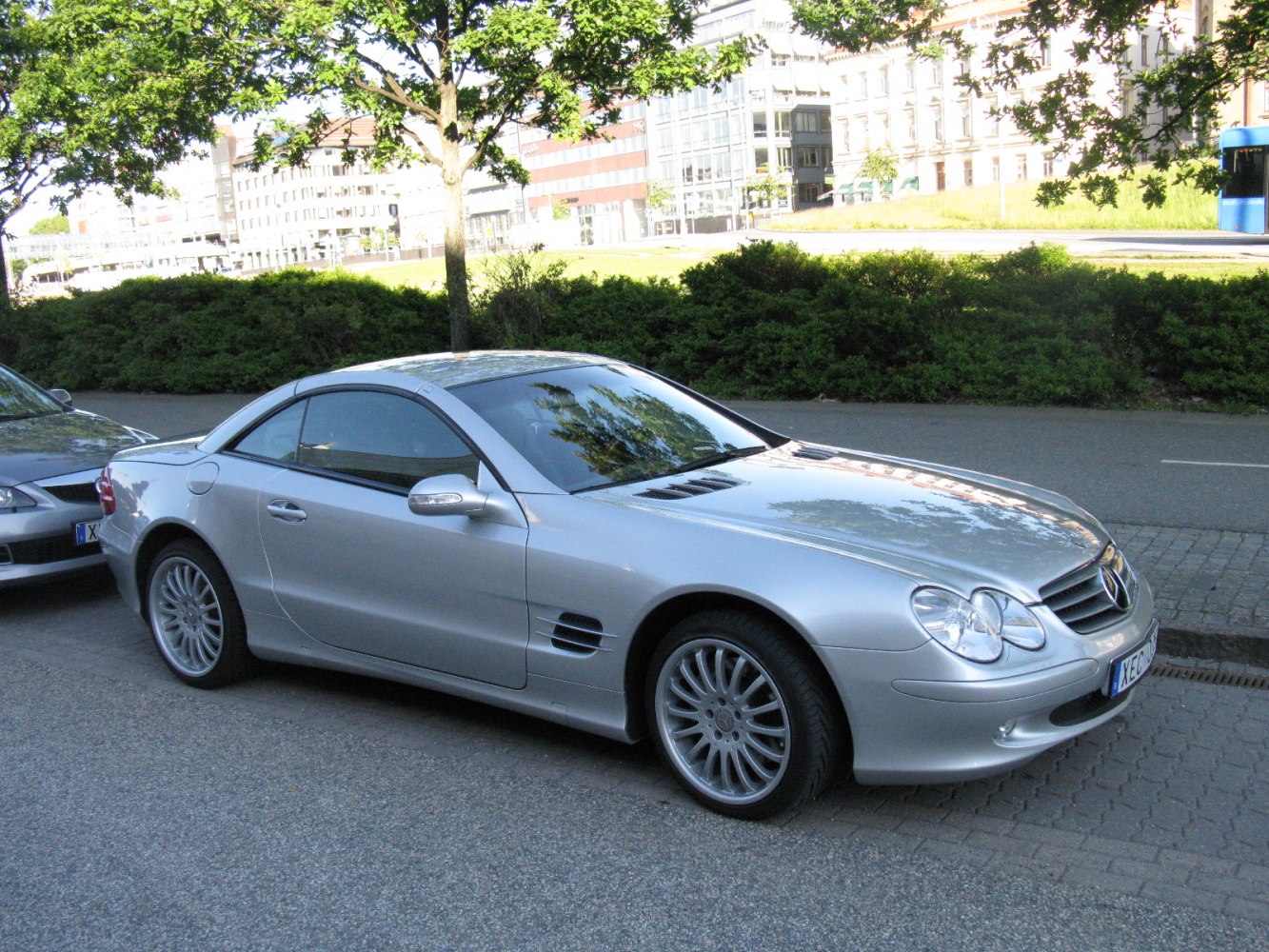 Silver luxury coupe with aerodynamic design and alloy wheels.