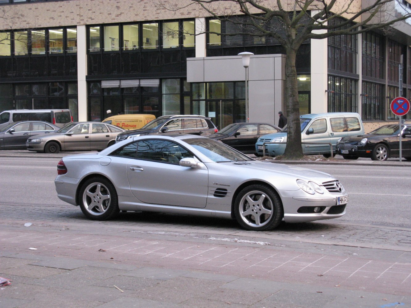 Silver luxury coupe with V8 badge and three-spoke alloy wheels