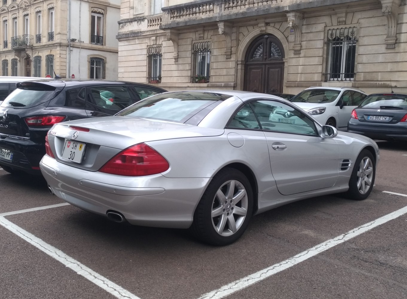 Silver luxury coupe rear view with alloy wheels and sleek design