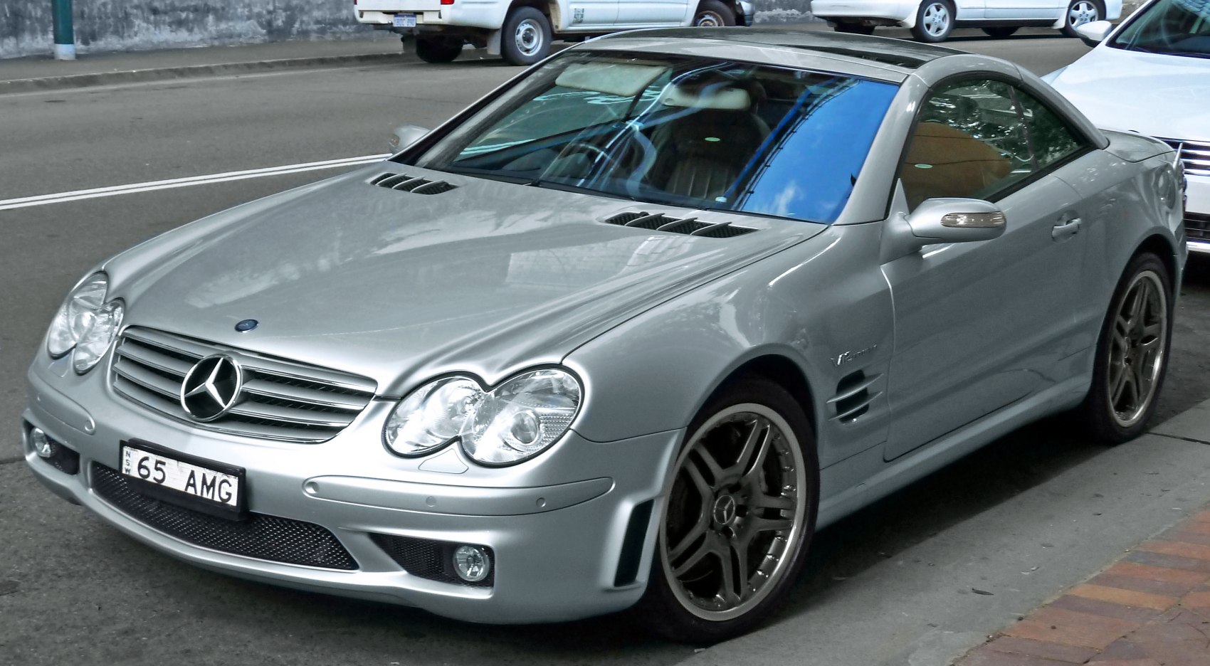Silver convertible with prominent front grille and sleek aerodynamic design
