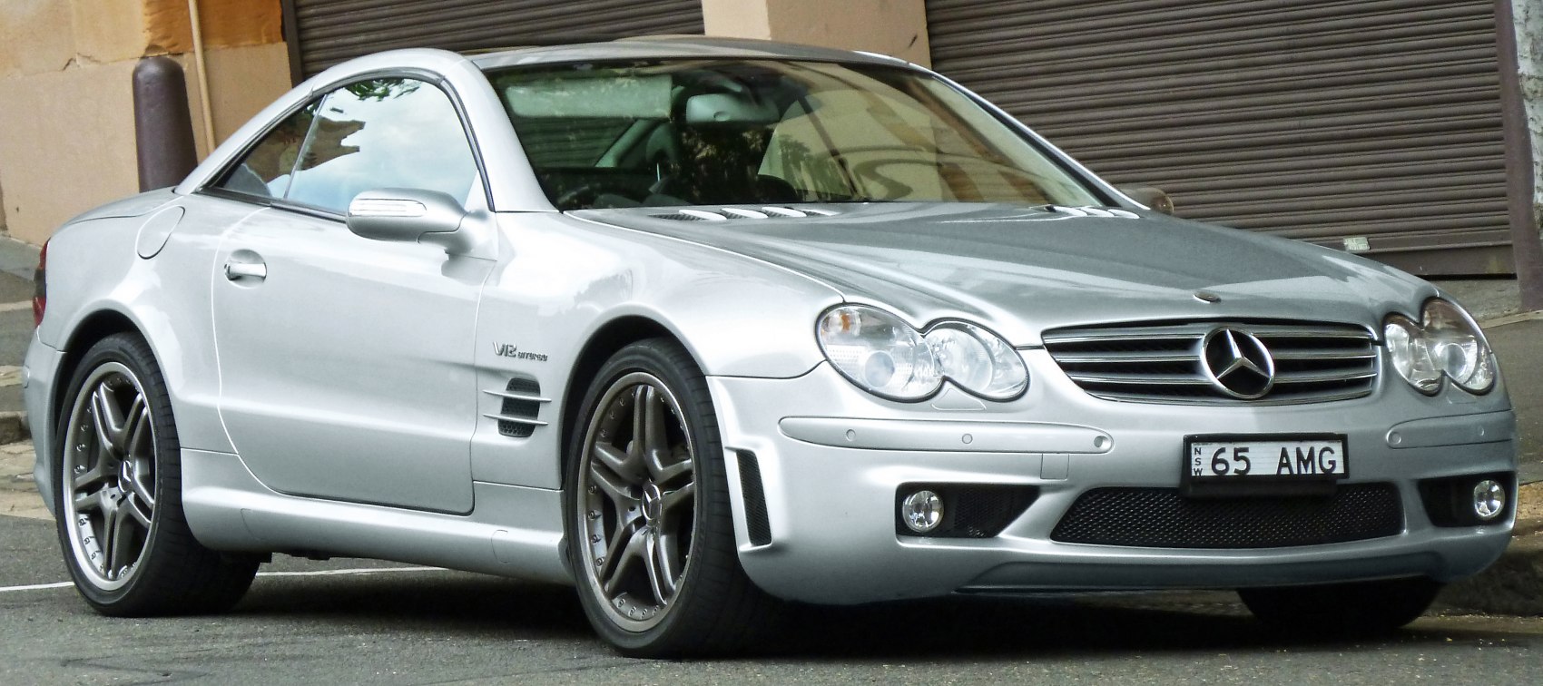 Silver two-door coupe front-side view with V12 engine and AMG wheels