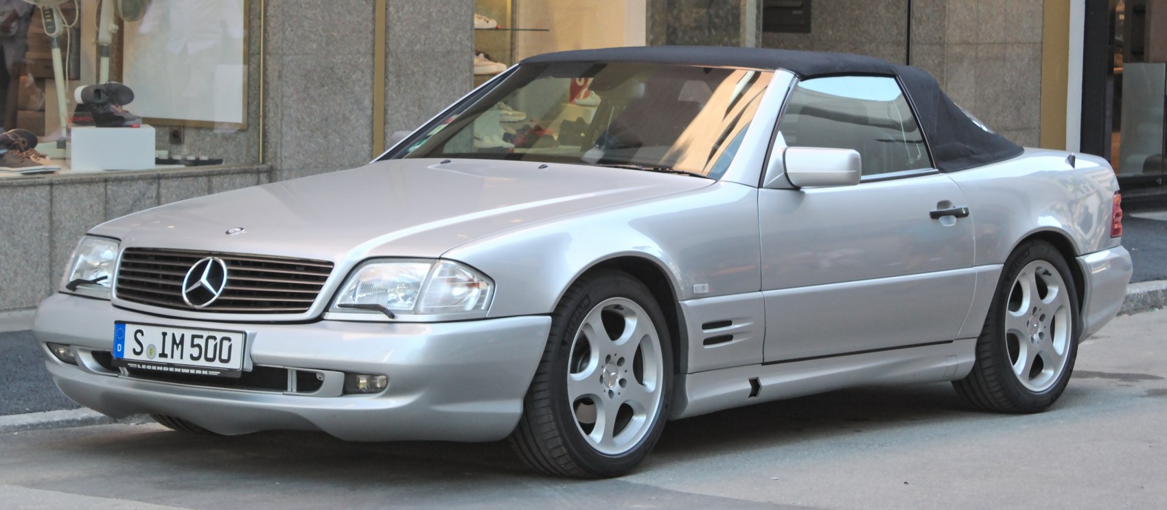 Silver convertible with soft top and five-spoke wheels