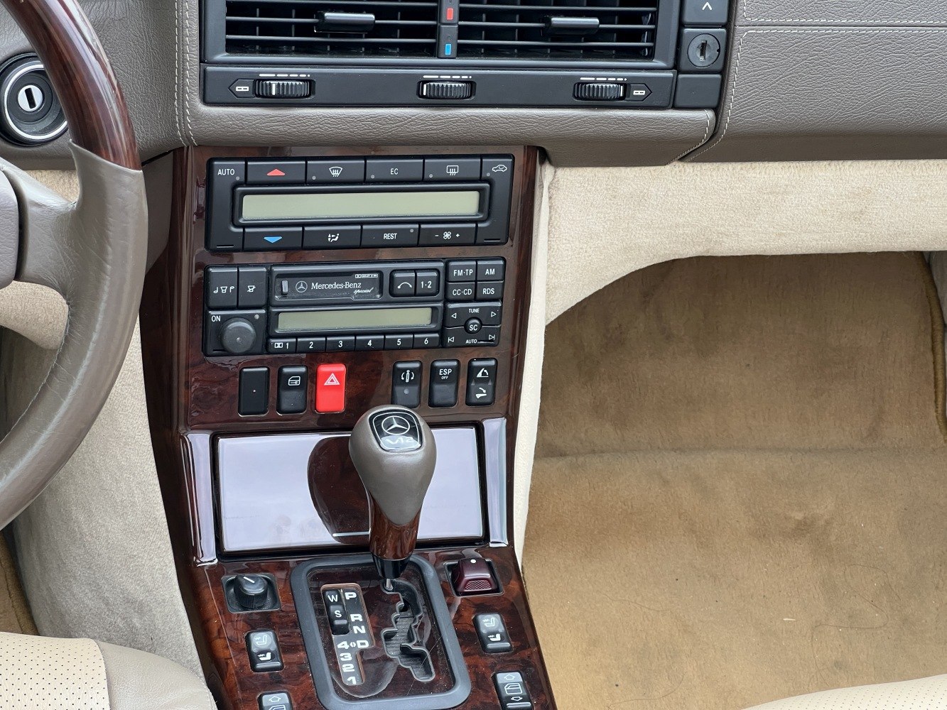 Close-up of classic car center console with automatic gear selector and wood trim