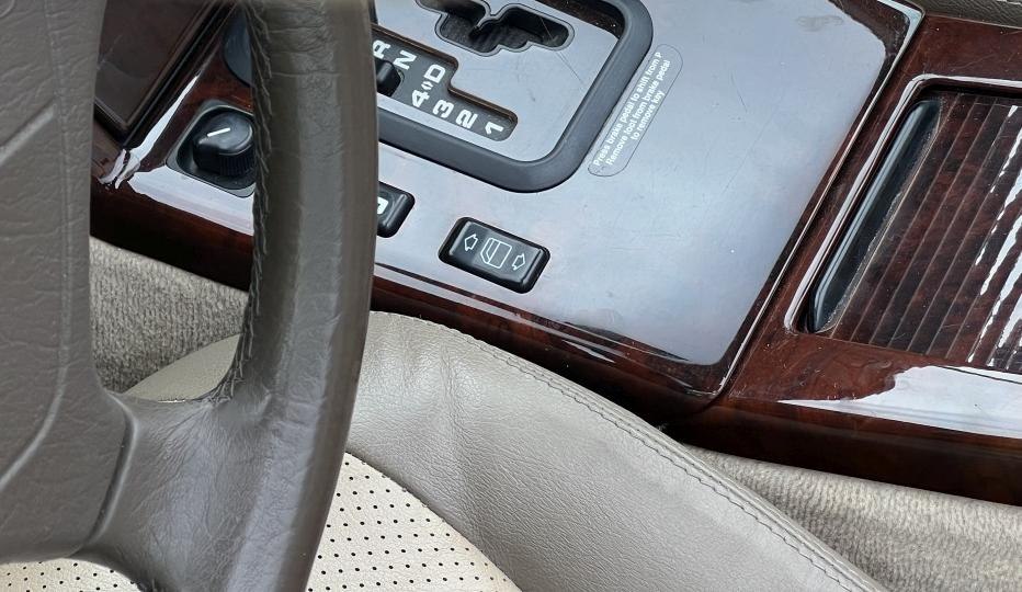 Automatic gear shift, window control buttons, wood trim, perforated leather seat