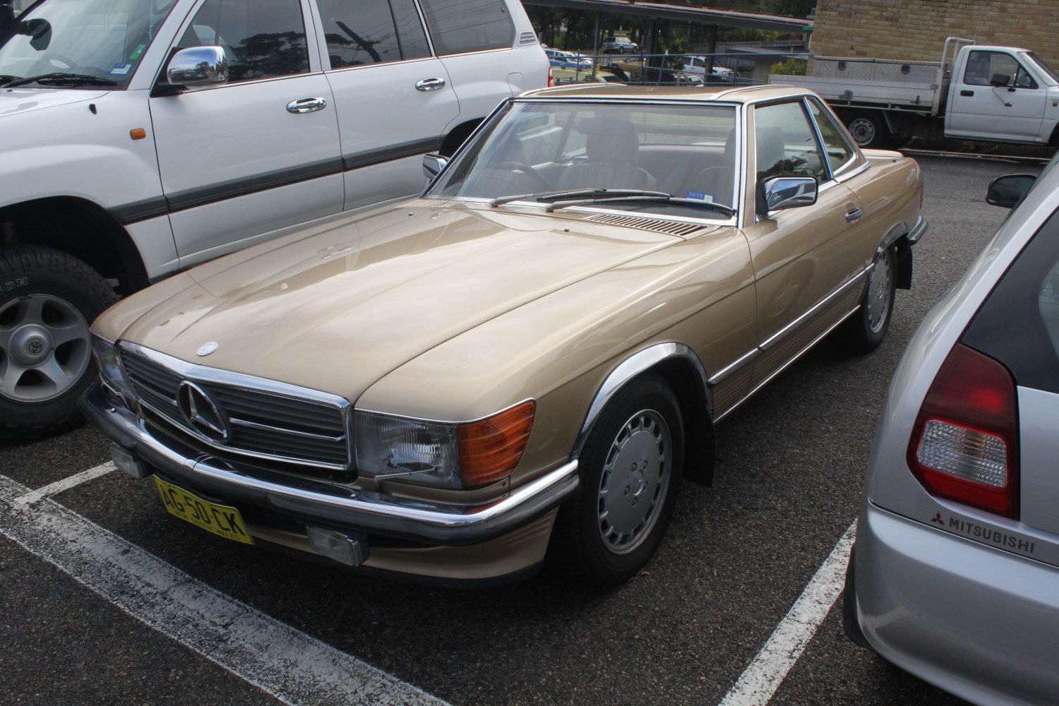 Classic 1980s two-door coupe with chrome grille and gold finish