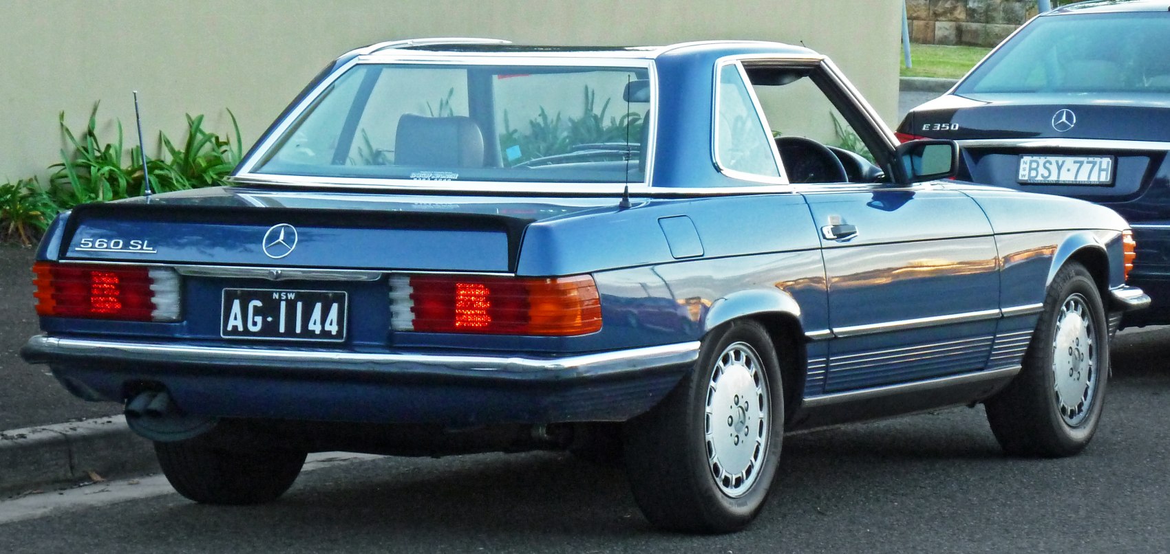 Rear view of luxury vintage convertible with distinct tail lights and chrome detail