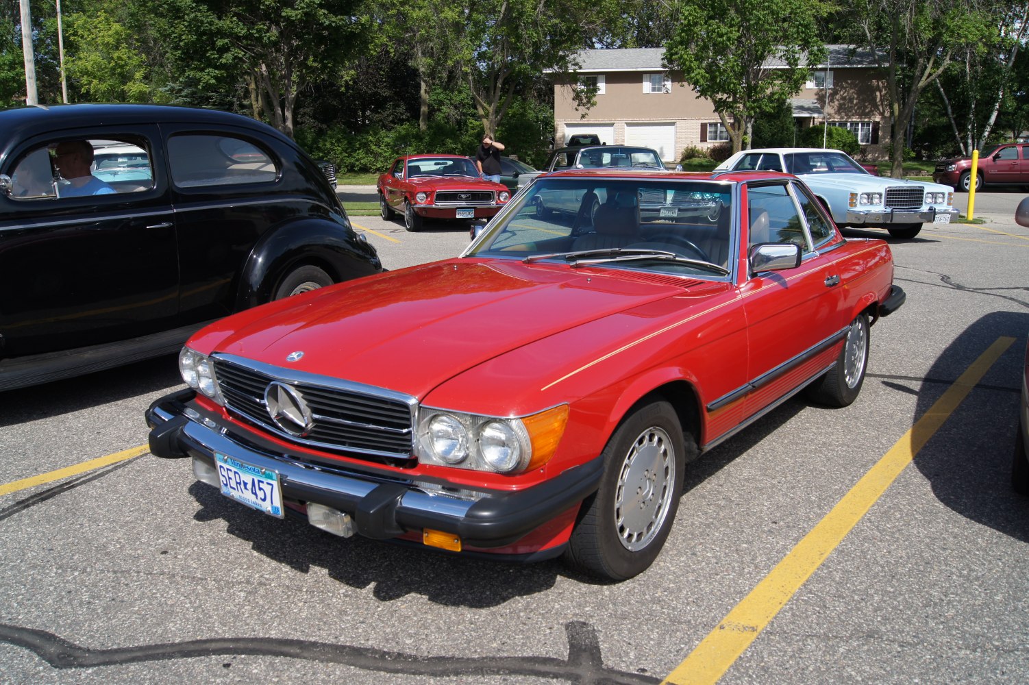 Red classic coupe with chrome grille and dual headlights