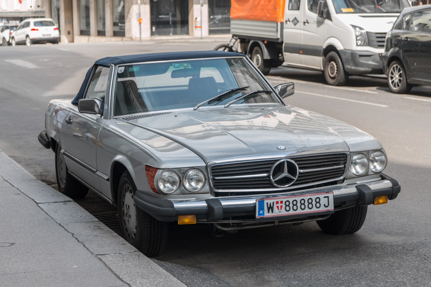 Classic convertible with dual round headlights and chrome grille