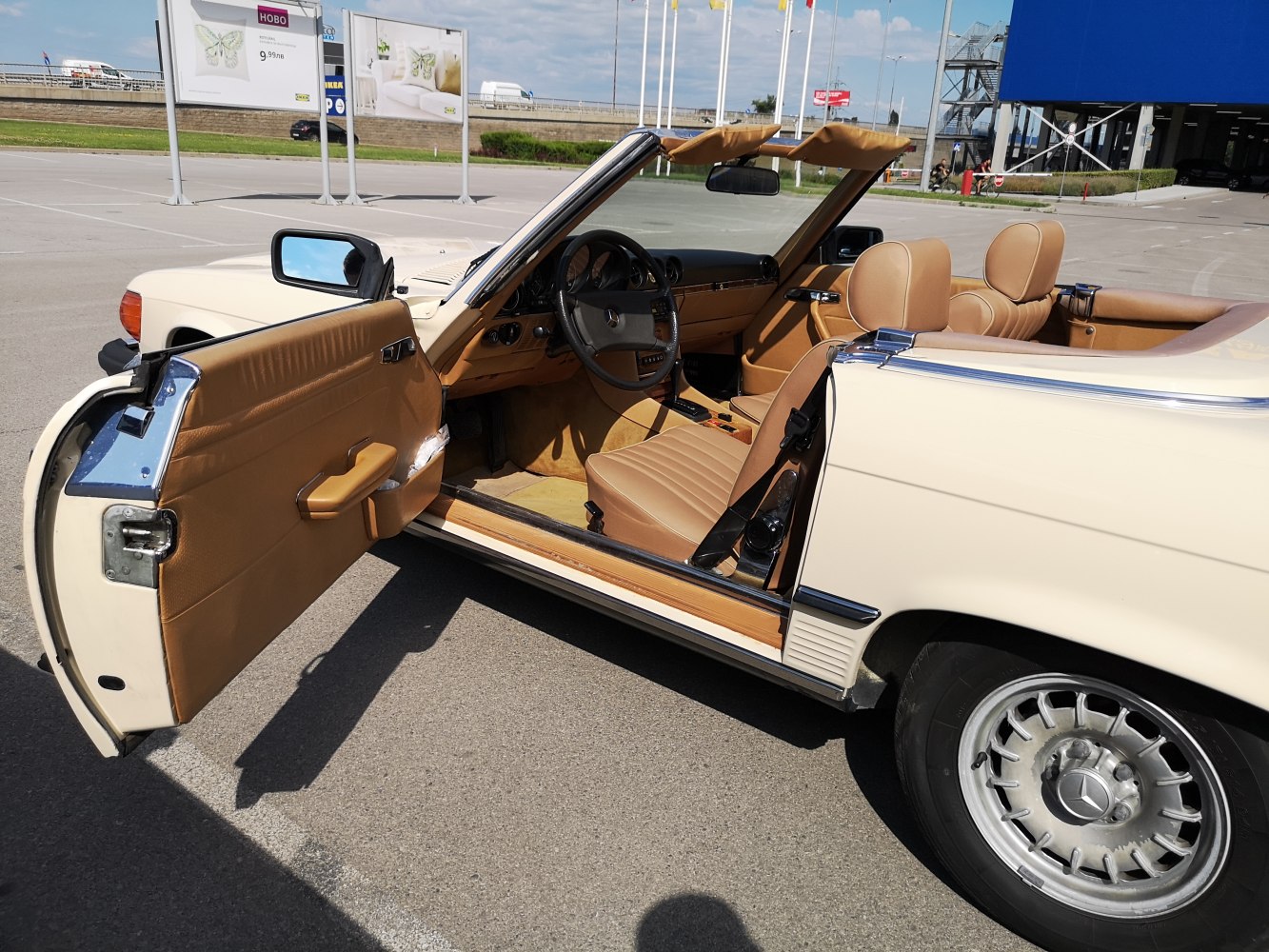 Tan leather interior and classic alloy wheel of vintage convertible roadster