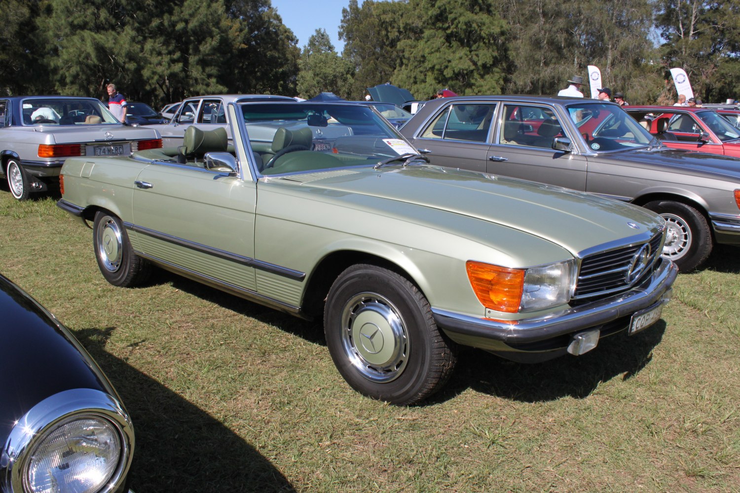 Vintage convertible roadster with chrome wheels and retro styling